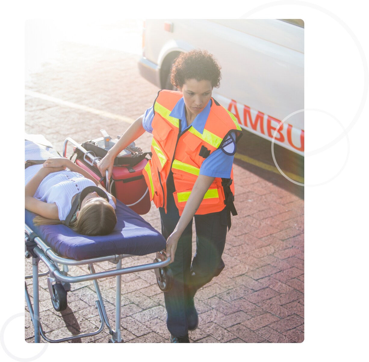 EMT moving a patient on an ambulance stretcher